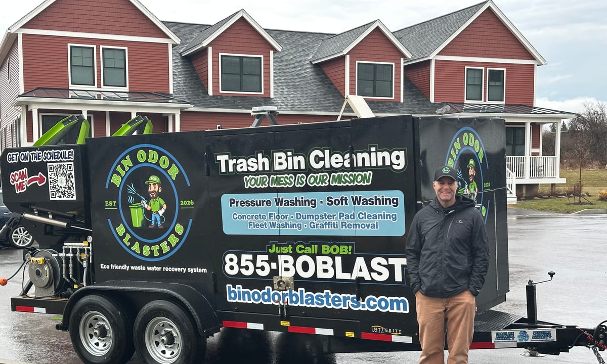 Mike Johnson standing beside the Bin Odor Blasters trailer in a Vermont neighborhood