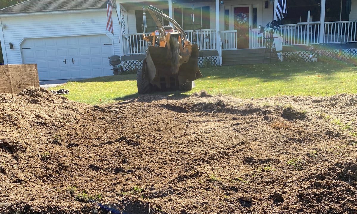 Mound of wood grindings left after a stump was removed, ready to be raked back into the lawn