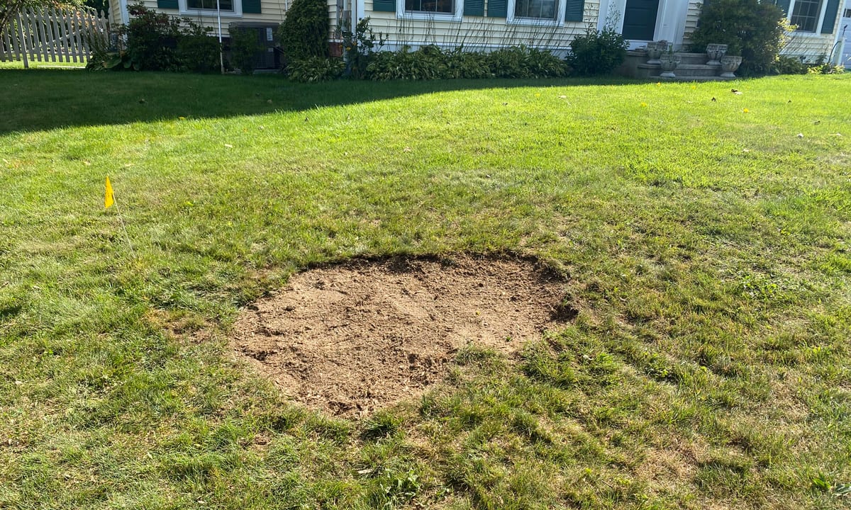 Lawn where a tree stump has been fully ground out and levelled by Grinding Gears in Vermont