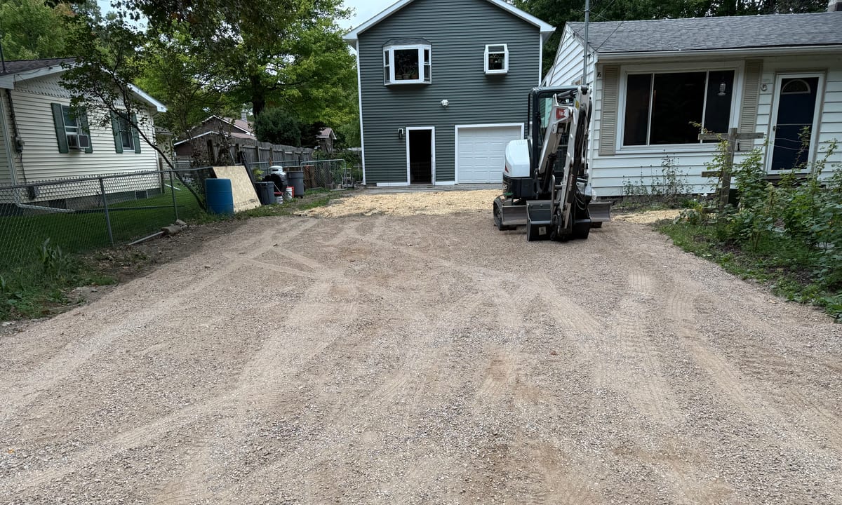 Freshly repaired gravel driveway running up to a Vermont home, completed by Magee's Excavation