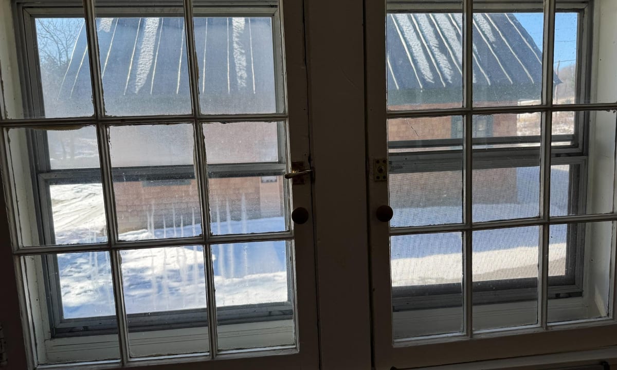 Before and after comparison of a grimy window and the same window after cleaning by Stone Window Cleaning